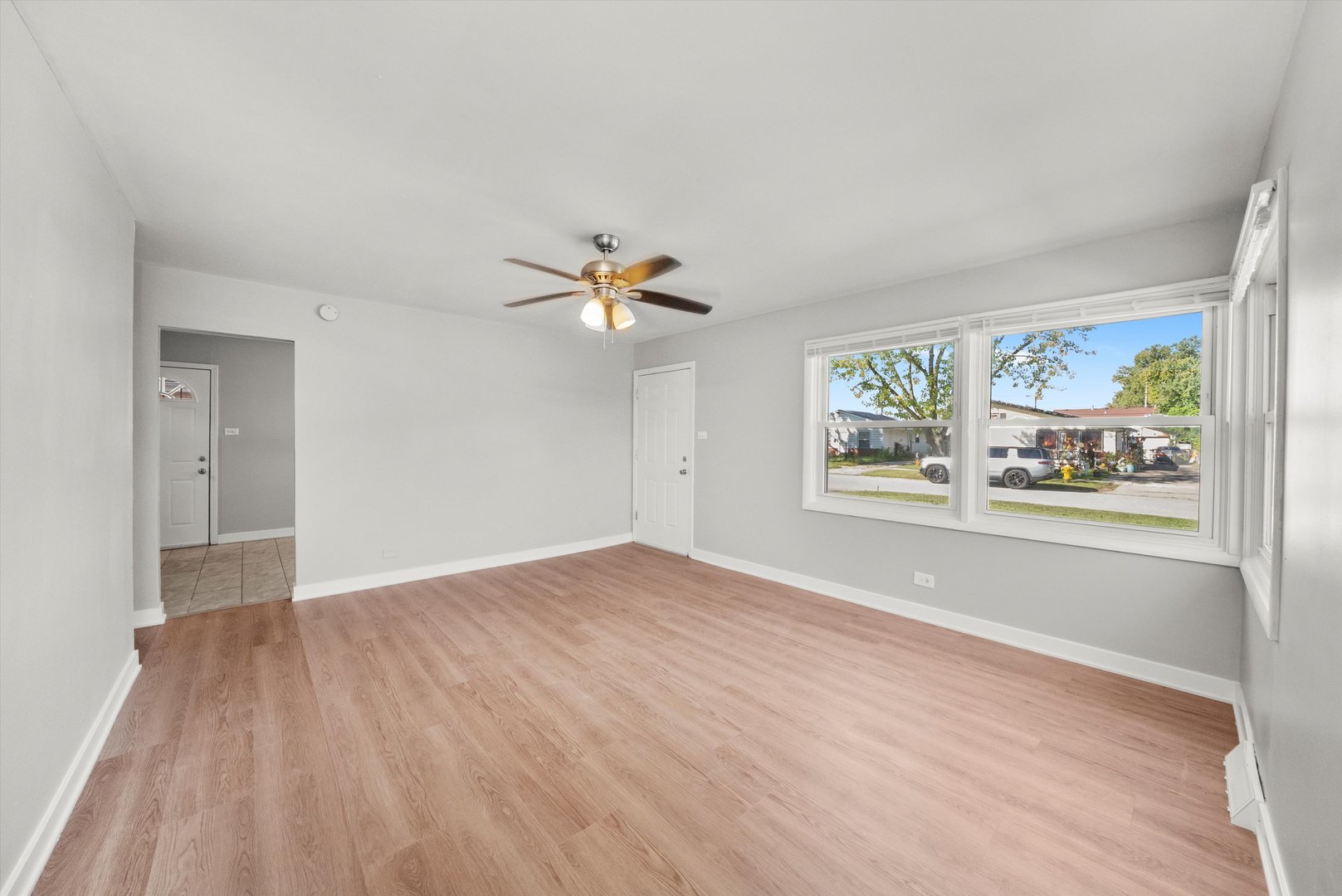 16333 Winchester Avenue Markham, IL 60428 - Photo 7 of 23 wooden floor in an empty room with a window