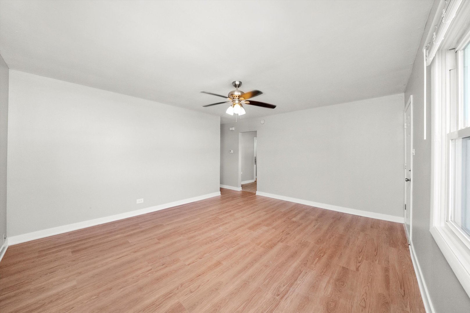 16333 Winchester Avenue Markham, IL 60428 - Photo 9 of 23 a view of a room with wooden floor and ceiling fan