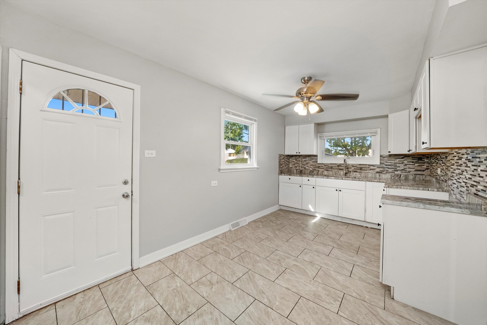 16333 Winchester Avenue Markham, IL 60428 - Photo 10 of 23 a kitchen with granite countertop a sink cabinets and window