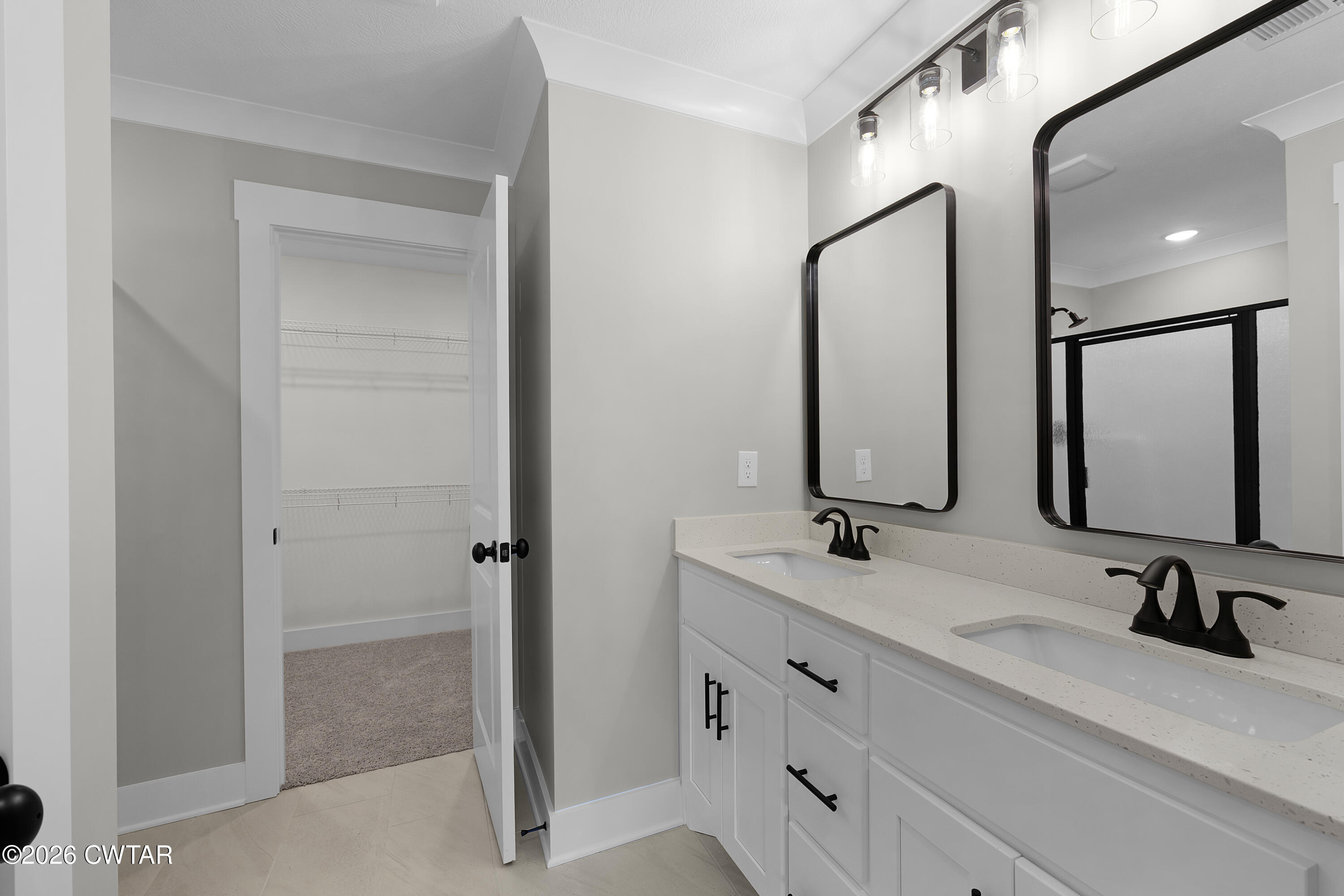 36 Easington Cove Jackson, TN 38305 - Photo 11 of 16 a bathroom with double vanity sink and mirror