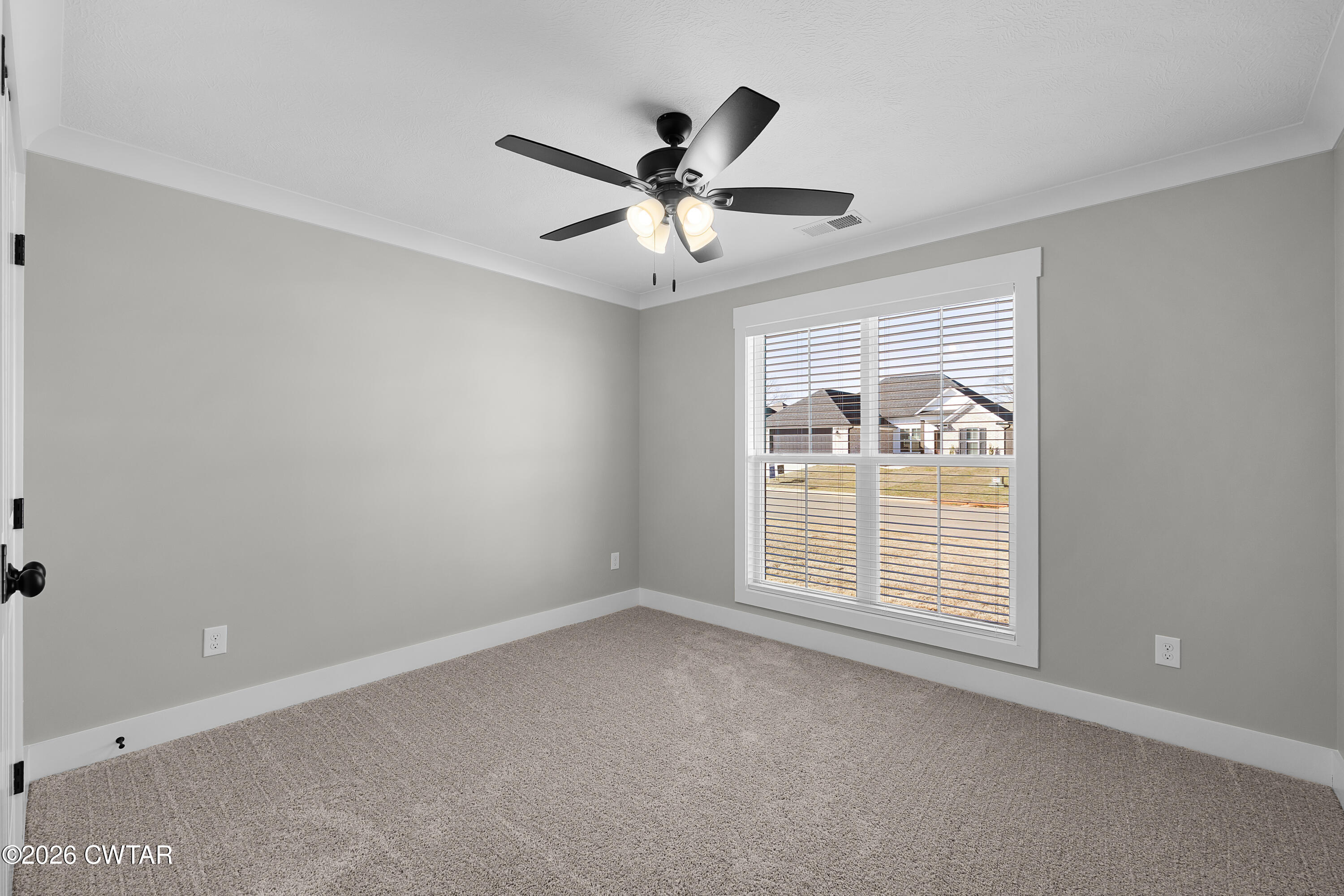 36 Easington Cove Jackson, TN 38305 - Photo 13 of 16 an empty room with ceiling fan and windows
