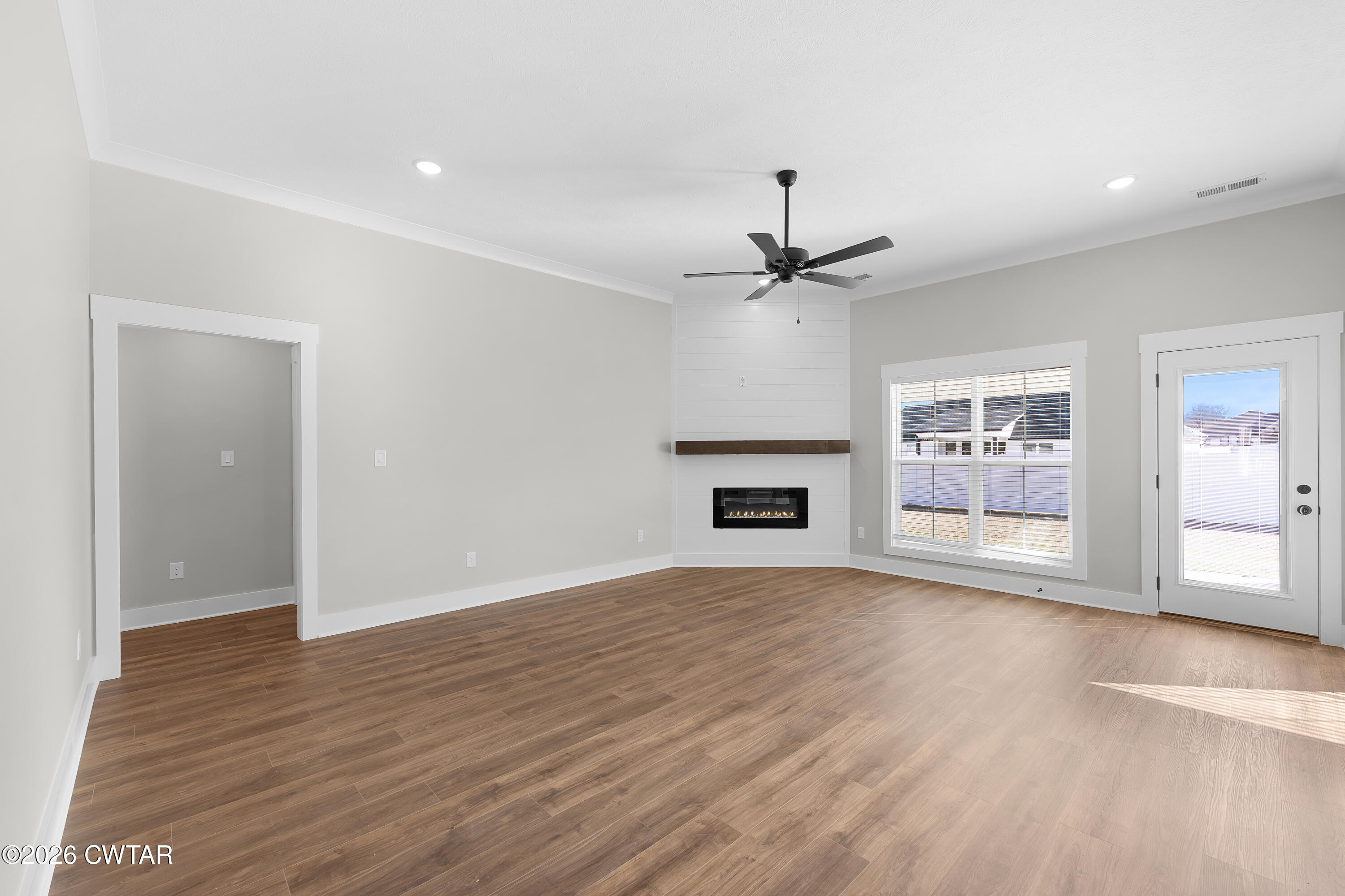 36 Easington Cove Jackson, TN 38305 - Photo 2 of 16 a view of an empty room with window and wooden floor