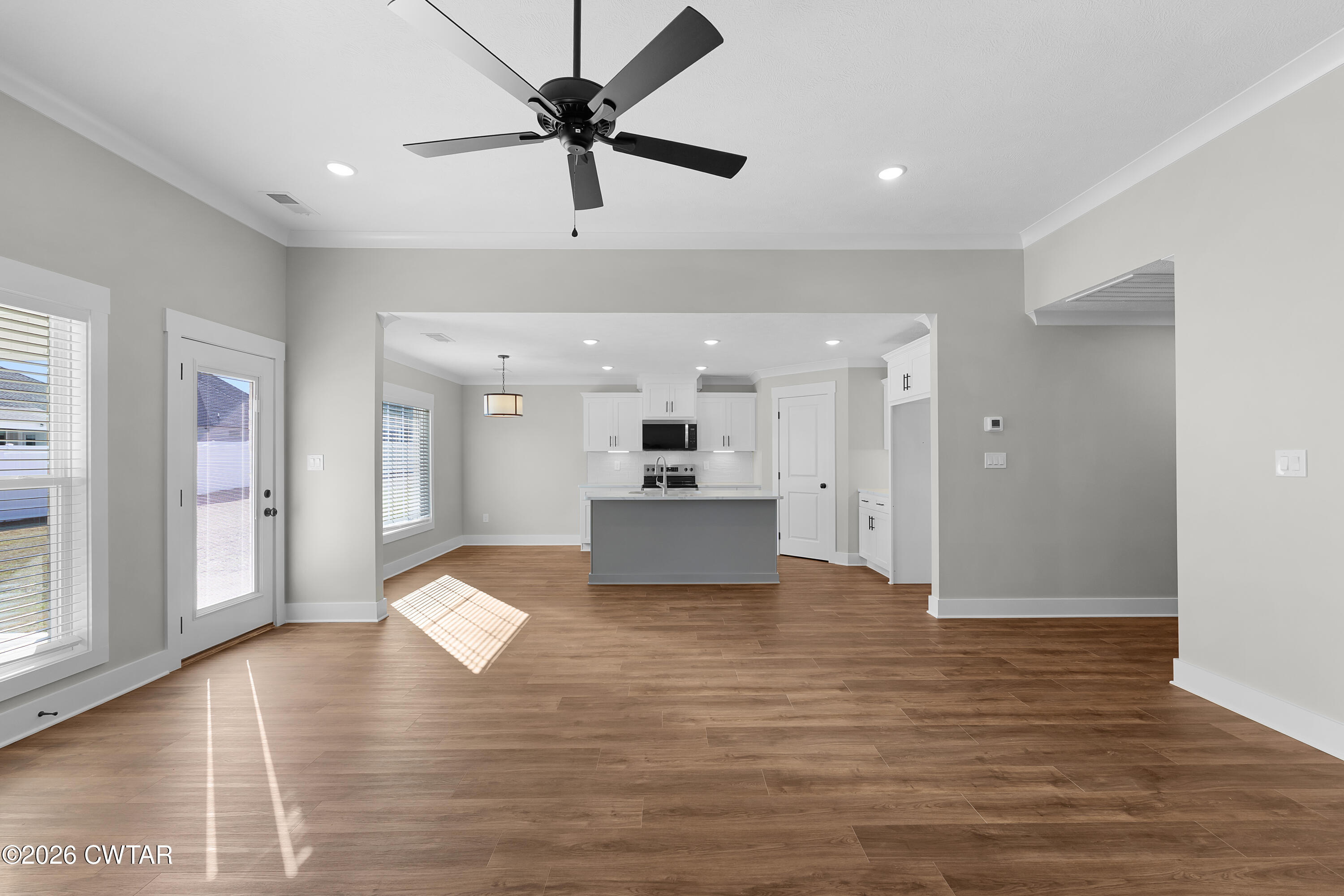 36 Easington Cove Jackson, TN 38305 - Photo 3 of 16 a view of a livingroom with kitchen island stainless steel appliances wooden floor and living room view