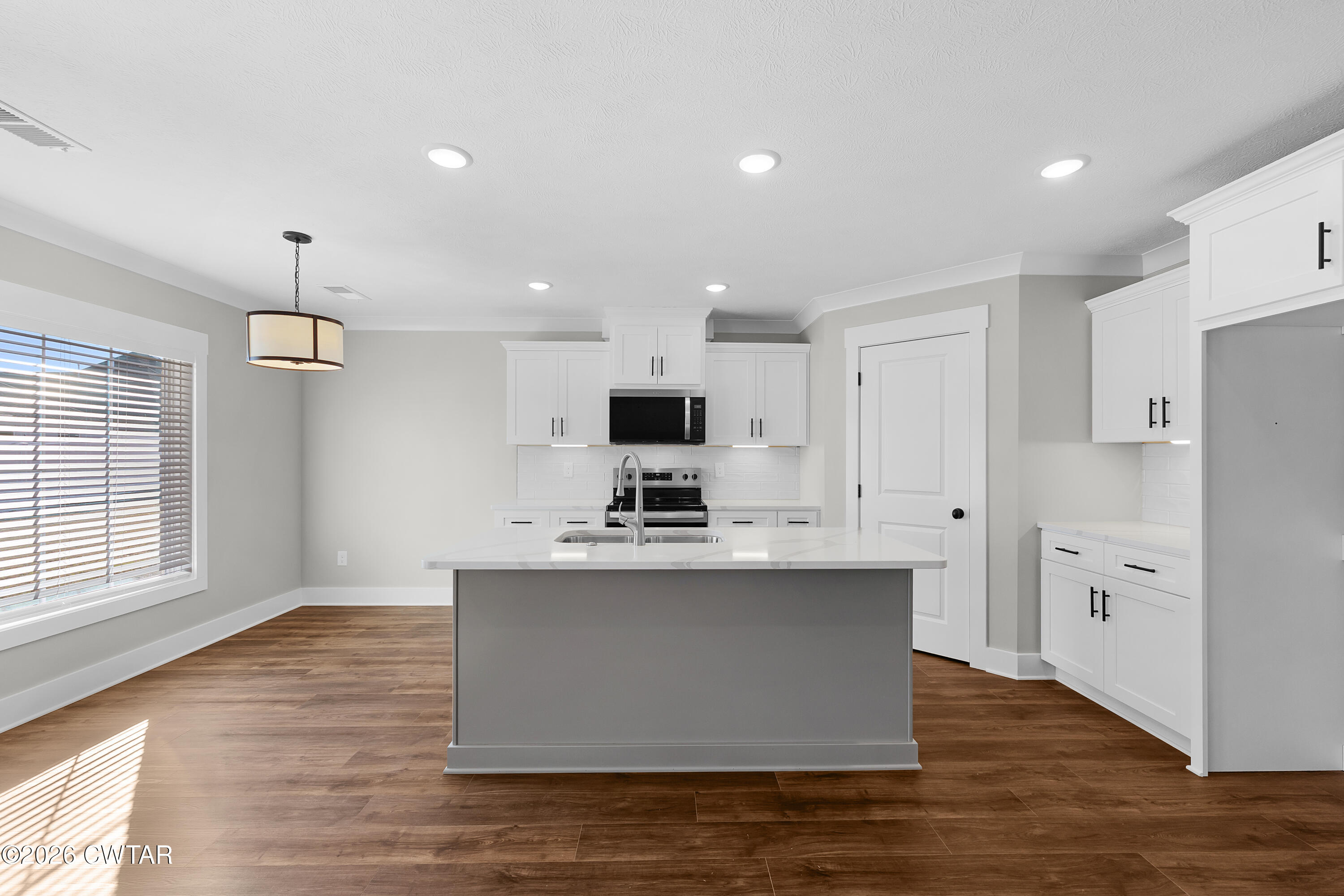 36 Easington Cove Jackson, TN 38305 - Photo 4 of 16 a view of kitchen with stainless steel appliances wooden floor sink stove and refrigerator