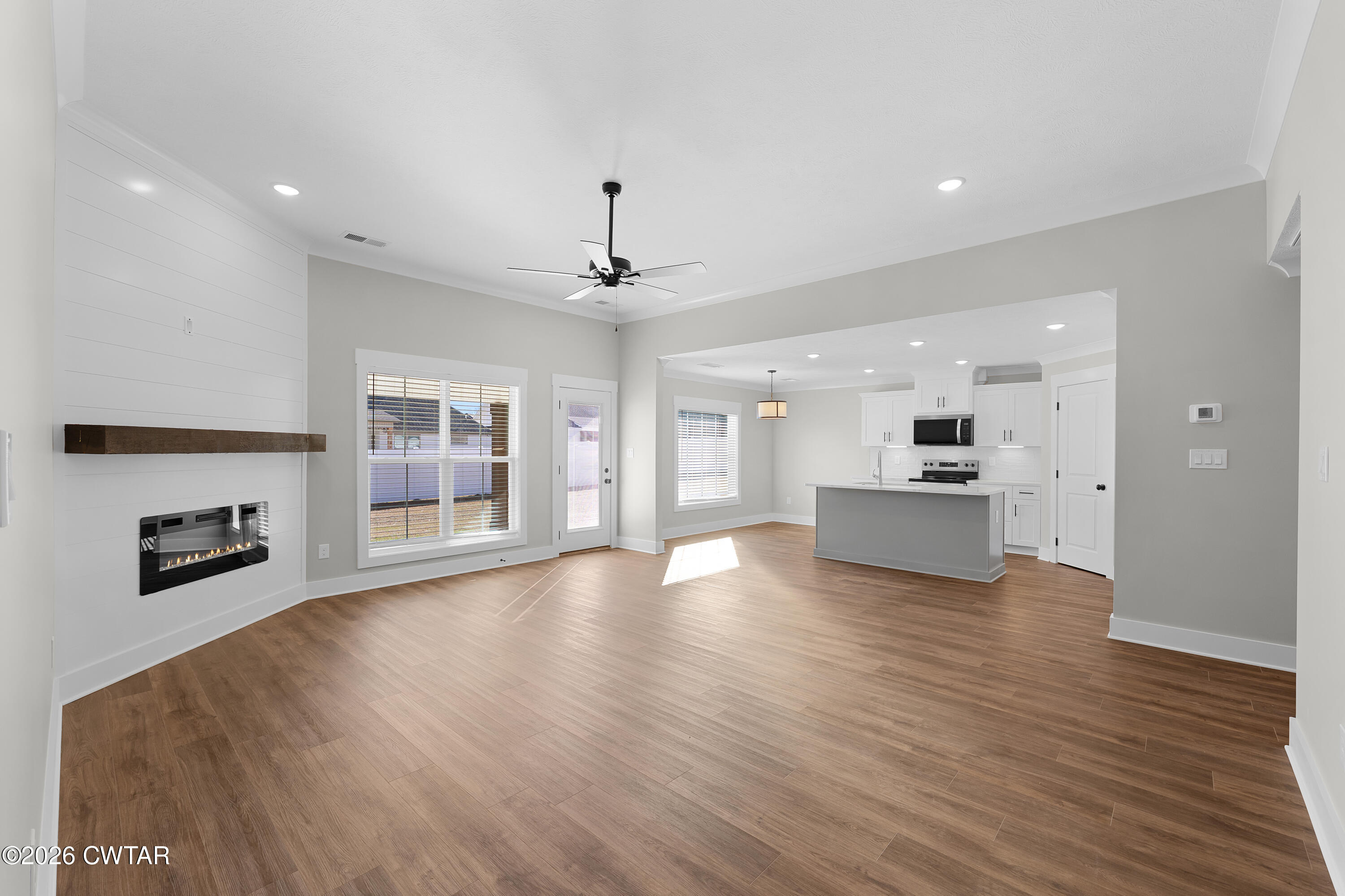 36 Easington Cove Jackson, TN 38305 - Photo 5 of 16 a view of an empty room with wooden floor and a kitchen