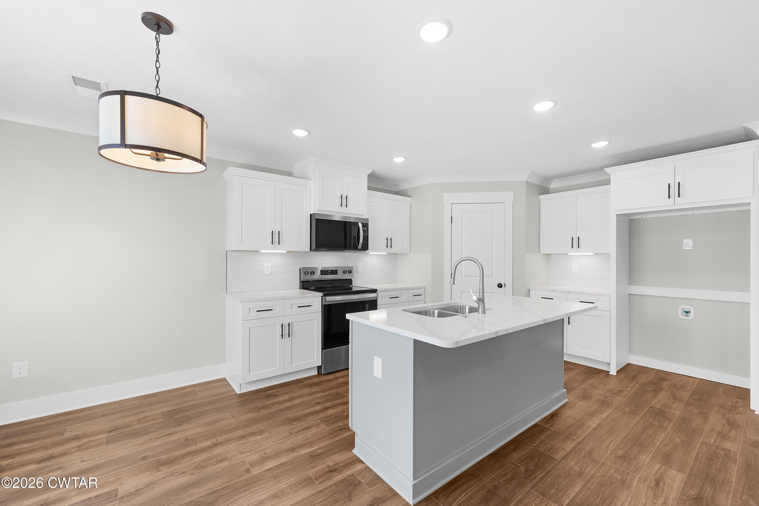 36 Easington Cove Jackson, TN 38305 - Photo 6 of 16 a kitchen with stainless steel appliances granite countertop a sink stove and refrigerator with wooden floor