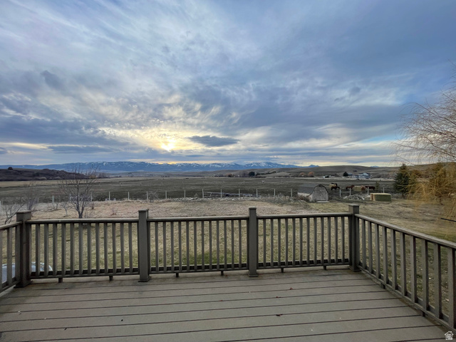 333 Lago Liberty Road Grace, ID 83241 - Photo 28 of 35 Wooden terrace featuring a mountain view, a view of countryside, and a storage shed
