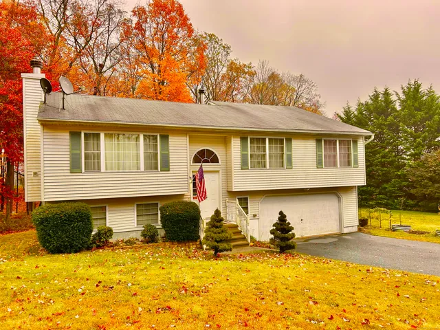 a front view of house with yard outdoor seating and barbeque oven