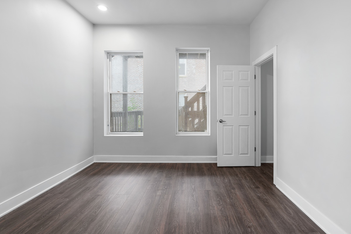 3003 West Fulton Street, Unit 1 Chicago, IL 60612 - Photo 12 of 29 an empty room with wooden floor and windows