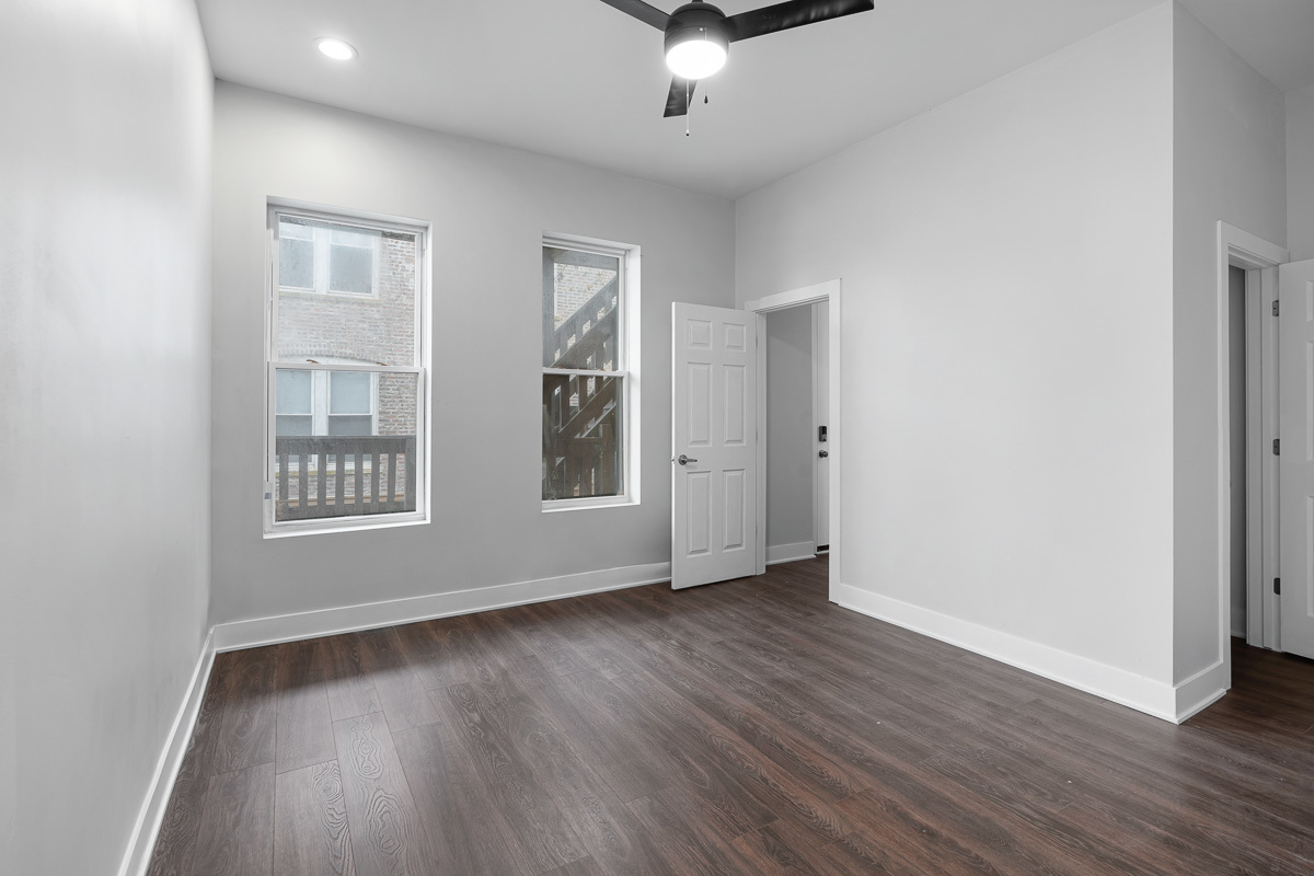 3003 West Fulton Street, Unit 1 Chicago, IL 60612 - Photo 13 of 29 a view of an empty room with wooden floor and a window