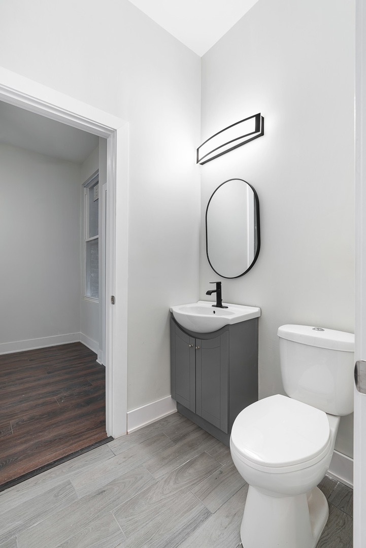 3003 West Fulton Street, Unit 1 Chicago, IL 60612 - Photo 18 of 29 a bathroom with a toilet sink and mirror