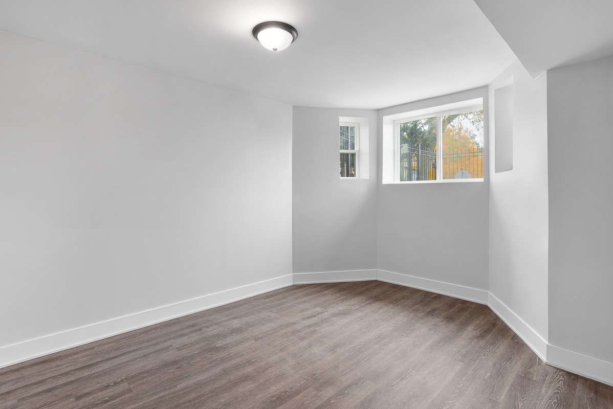 3003 West Fulton Street, Unit 1 Chicago, IL 60612 - Photo 23 of 29 an empty room with wooden floor and windows