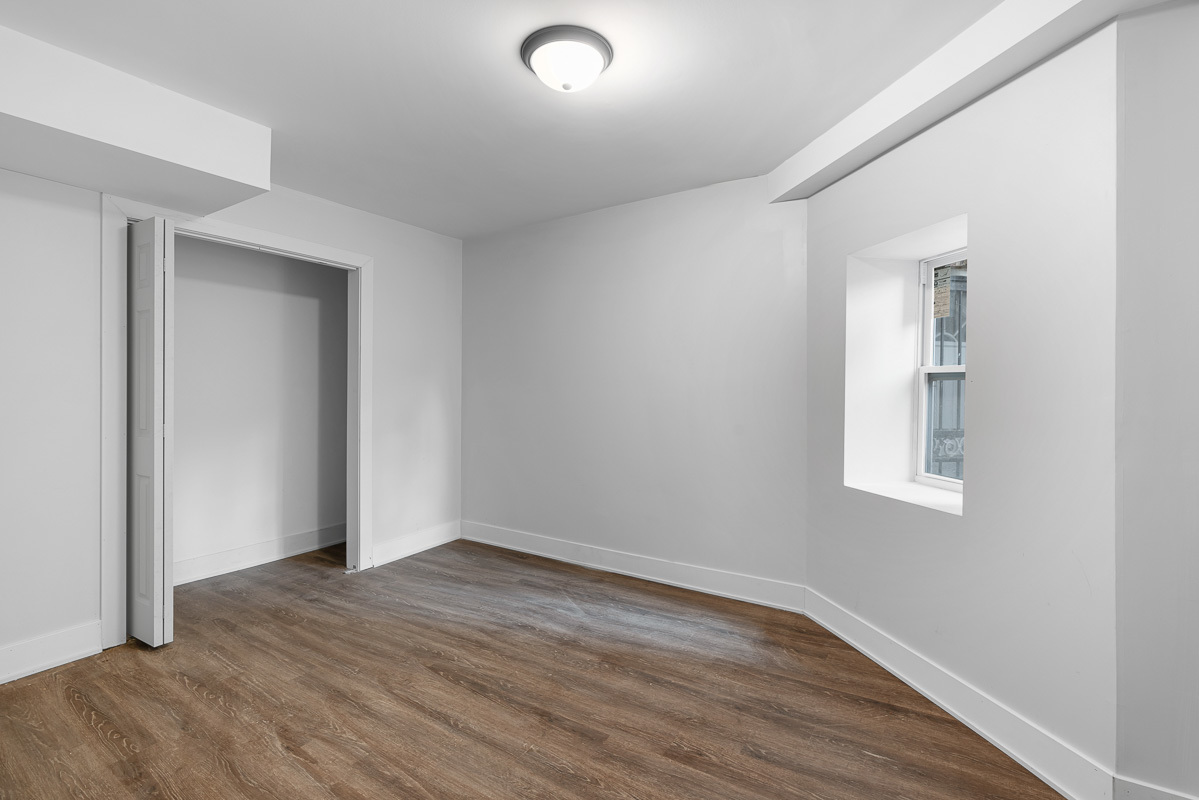 3003 West Fulton Street, Unit 1 Chicago, IL 60612 - Photo 25 of 29 an empty room with wooden floor and windows