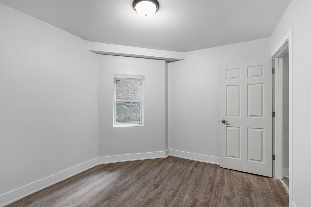3003 West Fulton Street, Unit 1 Chicago, IL 60612 - Photo 26 of 29 an empty room with wooden floor and closet