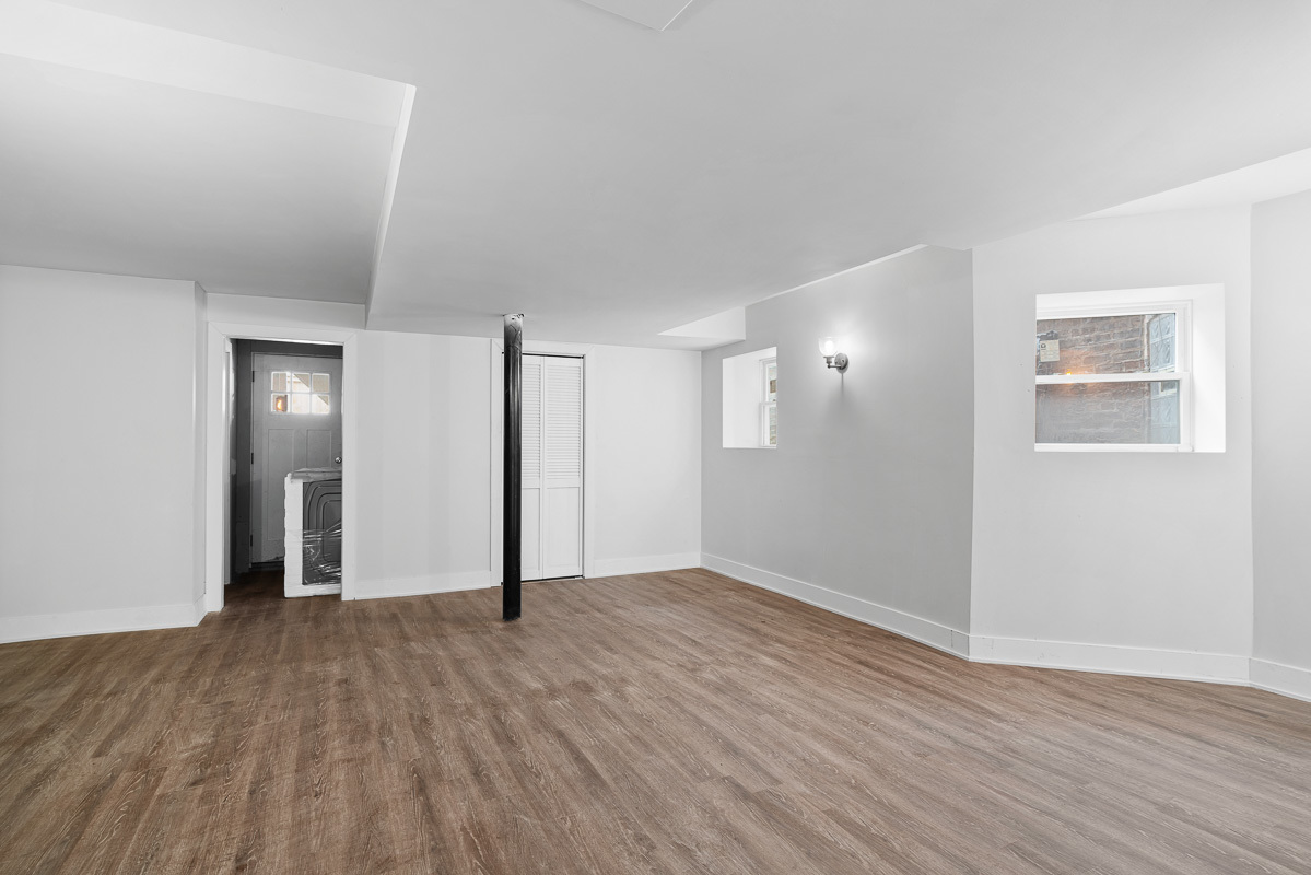 3003 West Fulton Street, Unit 1 Chicago, IL 60612 - Photo 28 of 29 an empty room with wooden floor and windows