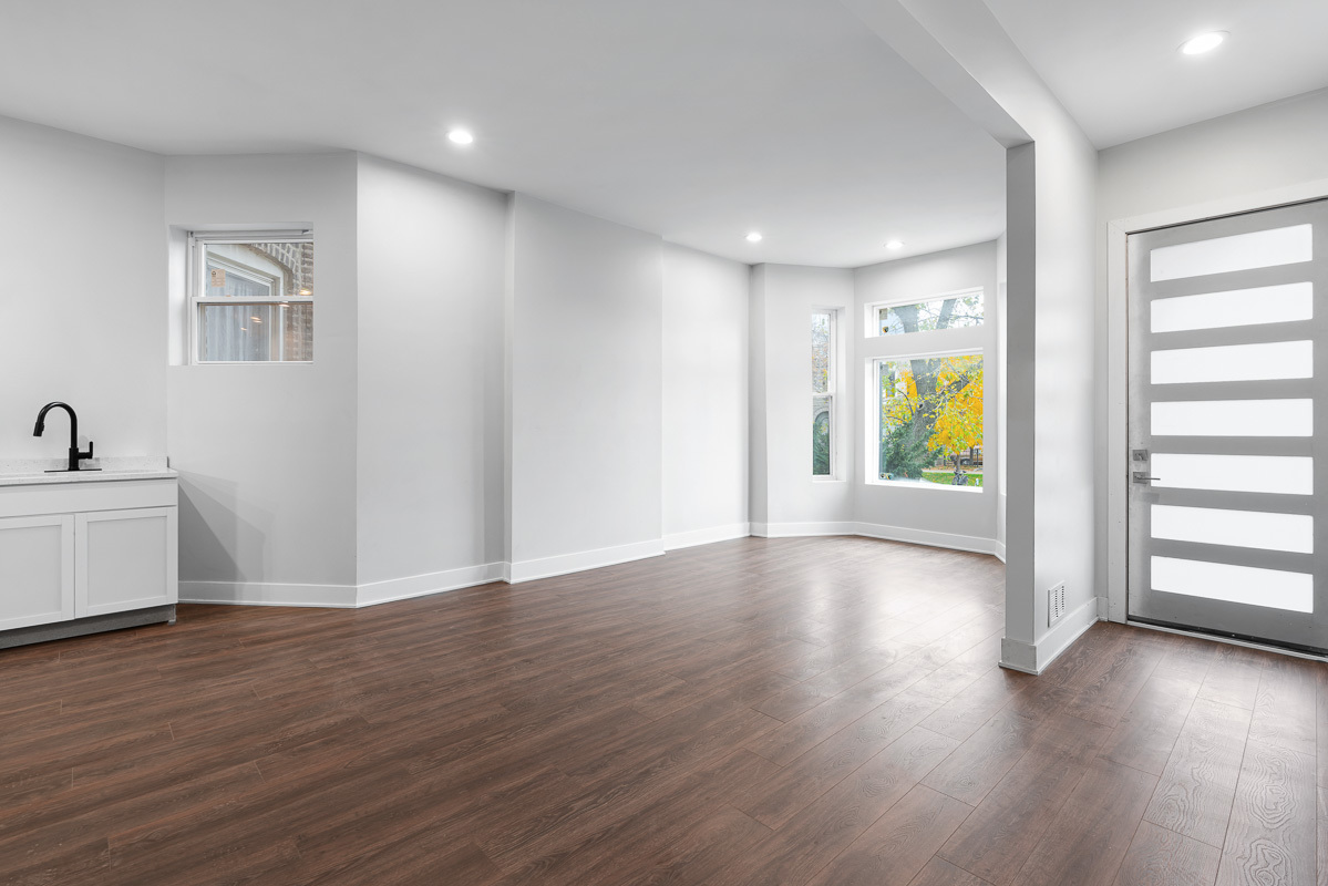 3003 West Fulton Street, Unit 1 Chicago, IL 60612 - Photo 3 of 29 a view of an empty room with wooden floor and a window