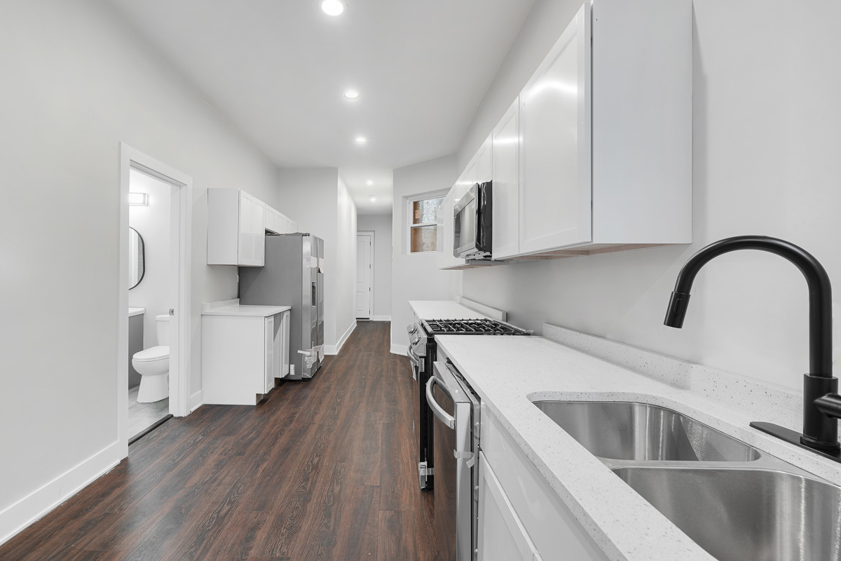 3003 West Fulton Street, Unit 1 Chicago, IL 60612 - Photo 6 of 29 a kitchen that has a lot of cabinets a sink and appliances in it