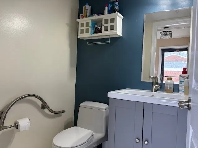 a bathroom with a sink a toilet and mirror