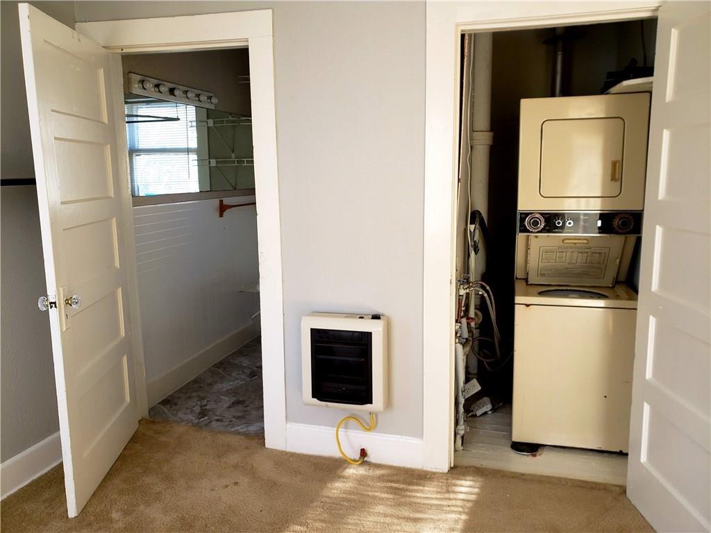 402 North Augusta Street Dallas, TX 75214 - Photo 6 of 11 a view of a kitchen from a hallway with wooden floor and closet
