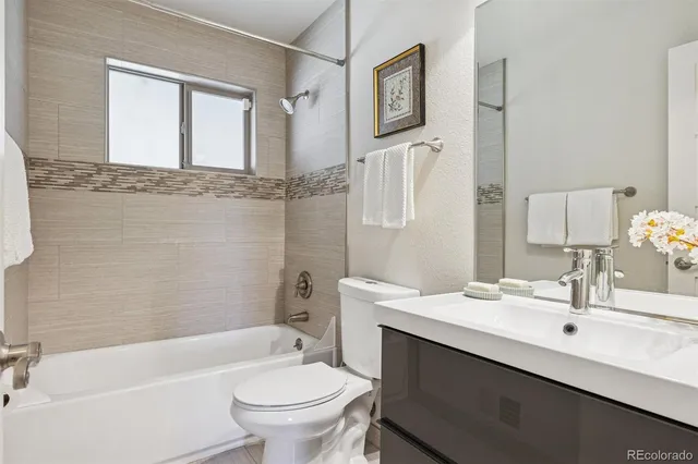 a bathroom with a sink toilet tub and shower