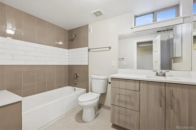 a bathroom with a sink a toilet and bathtub