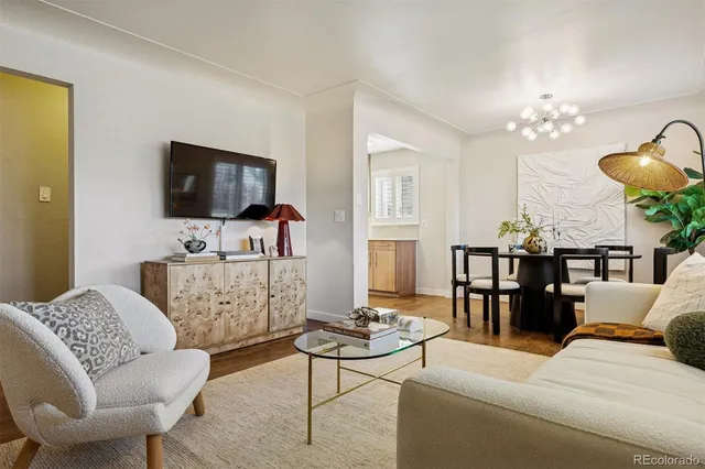 a living room with furniture a dining table and a flat screen tv