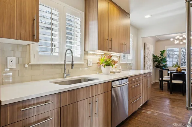 a kitchen with kitchen island granite countertop a sink and cabinets