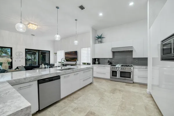 a view of staircase with lots of wooden floor and a chandelier