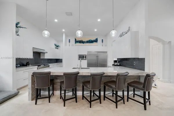 a view of a patio with couches chairs potted plants and a table
