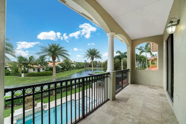 a view of swimming pool with outdoor seating and house in the background