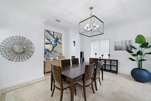 a view of a dining room with furniture and chandelier