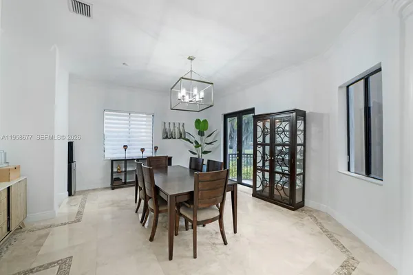 a view of a dining room with furniture and window