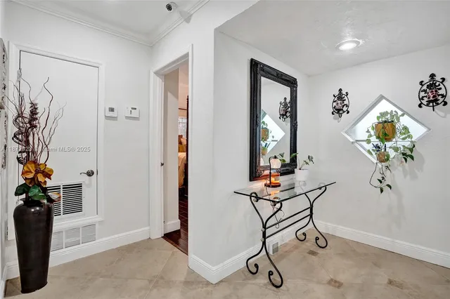 a view of a hallway with furniture and a potted plant