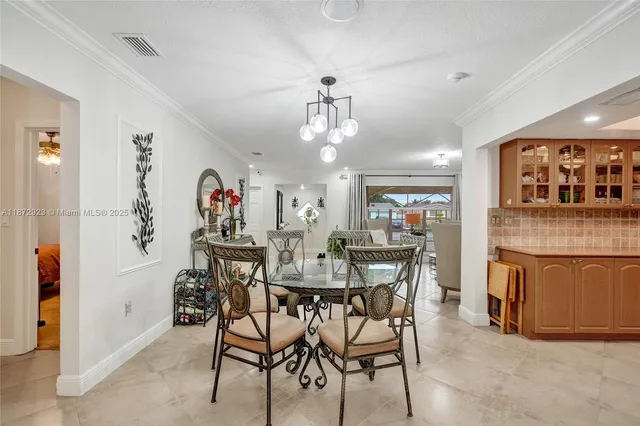 a view of a dining room with furniture a chandelier and wooden floor