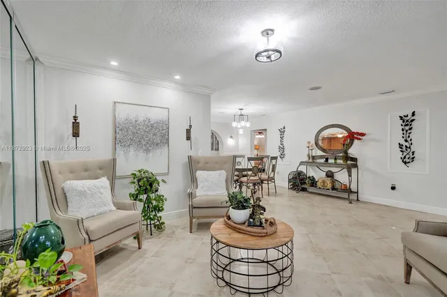 a living room with furniture and a chandelier