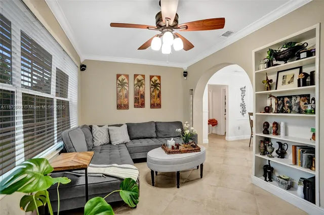 a living room with furniture a rug and a window