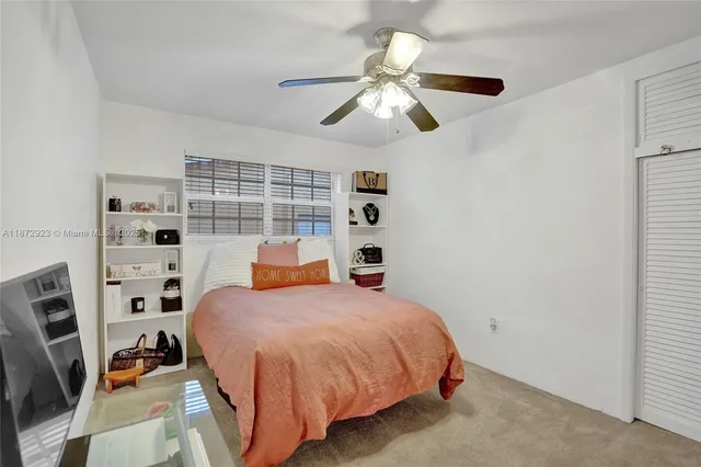 a bedroom with a bed and cabinets
