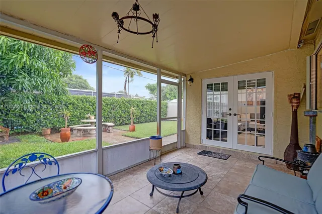 a room with furniture and a floor to ceiling window