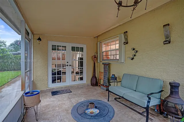 a living room with furniture a rug and a large window