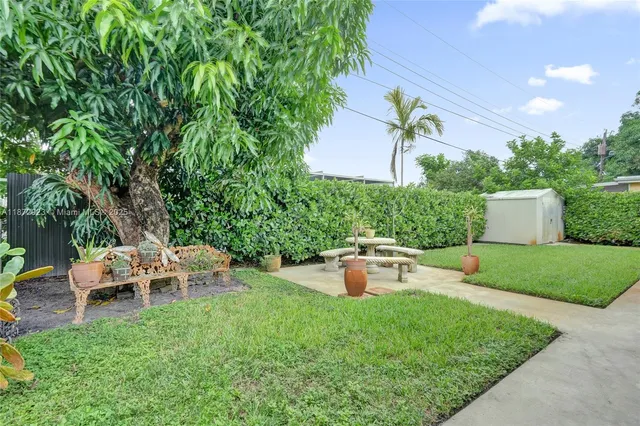 a view of a house with backyard sitting area and garden