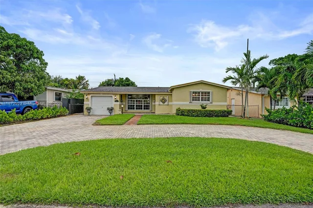 a front view of house with yard and green space