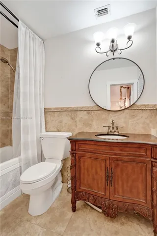 a bathroom with a sink mirror vanity and toilet