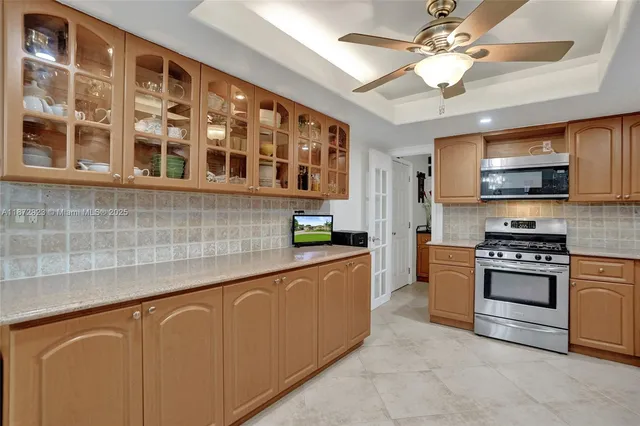 a kitchen with stainless steel appliances granite countertop a refrigerator a stove a sink dishwasher a oven with a dining table and chairs