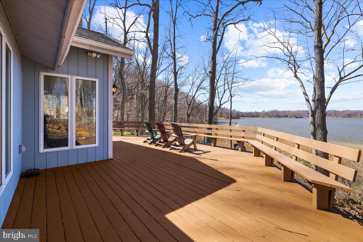 12440 Woods Road Worton, MD 21678 - Photo 1 of 37 a view of a balcony with chairs and wooden floor