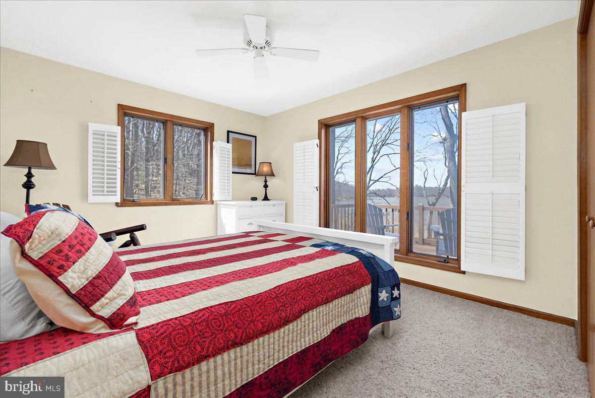 12440 Woods Road Worton, MD 21678 - Photo 17 of 37 a bedroom with a bed and a large window