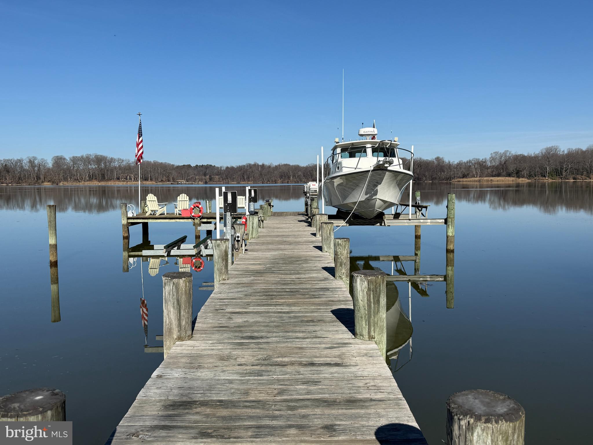 12440 Woods Road Worton, MD 21678 - Photo 6 of 37 a view of a lake with boats and trees in the background