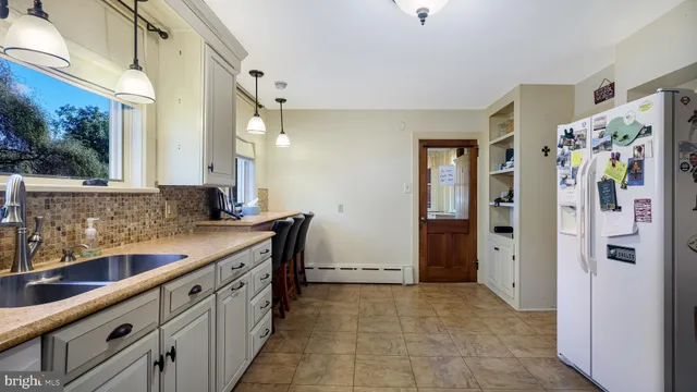 a kitchen with stainless steel appliances a sink and a refrigerator