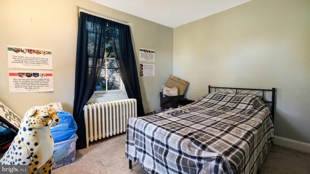 a bed sitting in a bedroom next to a window