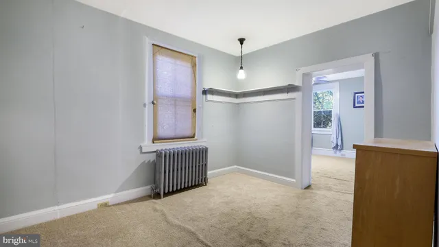 an empty room with windows and closet