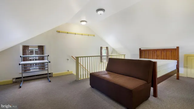 a bedroom with furniture and a book shelf